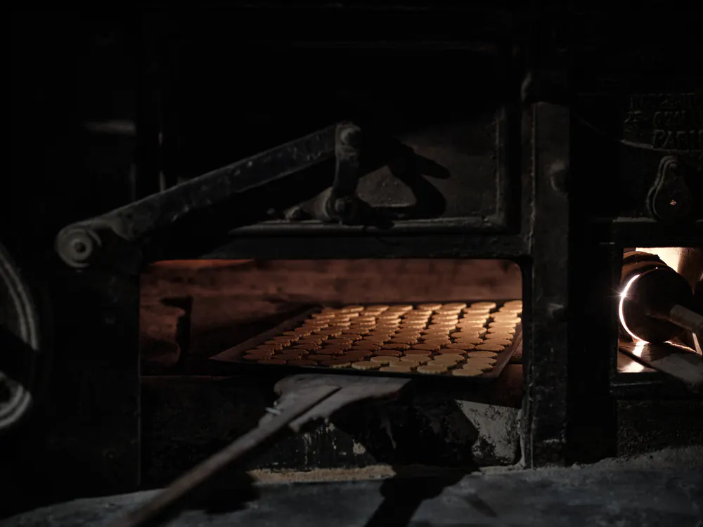 A tray of biscuits baking inside a traditional oven.